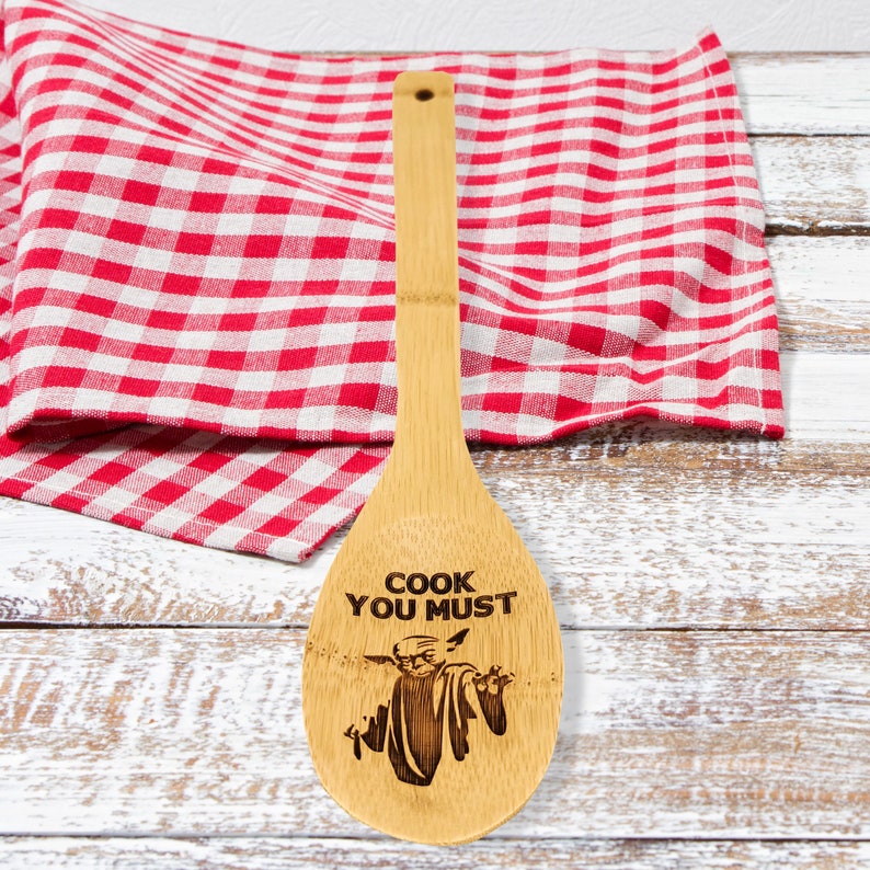 Bamboo  spoon is engraved with Baby Yoda and the inscription - cook you must. The engraved spoon is designed for Star Wars fans.