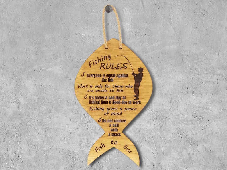 The fishing rules are made of wood. The laser-cut fish-shaped board is engraved with various fishing rules. The rules come with a linen cord for hanging.