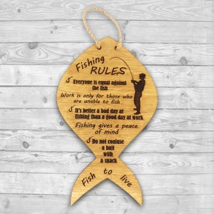 The fishing rules are made of wood. The laser-cut fish-shaped board is engraved with various fishing rules. The rules come with a linen cord for hanging.