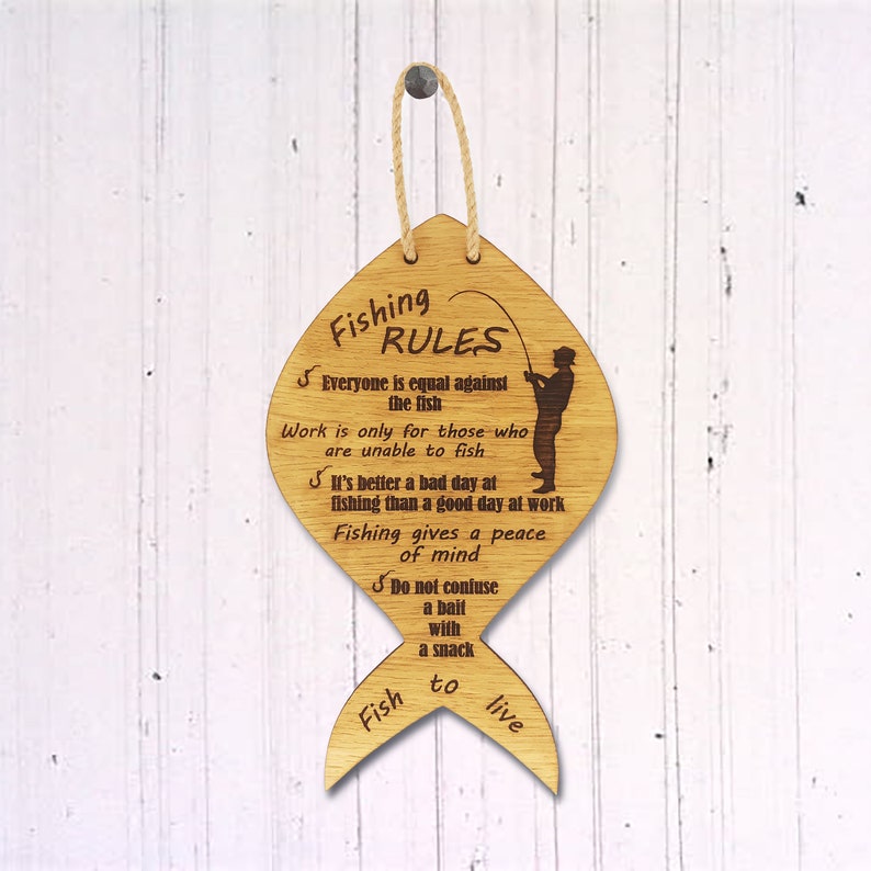 The fishing rules are made of wood. The laser-cut fish-shaped board is engraved with various fishing rules. The rules come with a linen cord for hanging.