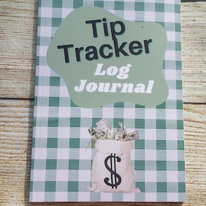 May include: A Tip Tracker Log Journal with a green and white gingham pattern. The cover features the text "Tip Tracker Log Journal" in a stylized font. A money bag graphic with a dollar sign is also on the cover.