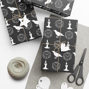May include: Black and white gift wrap with a repeating pattern of candles, ravens, and 20-sided dice. The dice have the number 20 and the letter B on them.