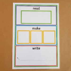 May include: A white educational chart with the words "read", "make", and "write" in a colorful border. The chart has a rectangular space for reading, three squares for making, and a space for writing with a dotted line.
