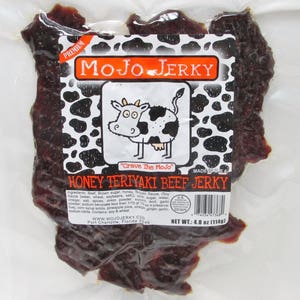 May include: A package of honey teriyaki beef jerky with a cartoon cow on the label. The label reads "Mojo Jerky" and "Crave the Mojo". The net weight is 4.0 oz (114g).