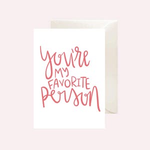 May include: A white card with the text "You're my favorite person" written in pink cursive.