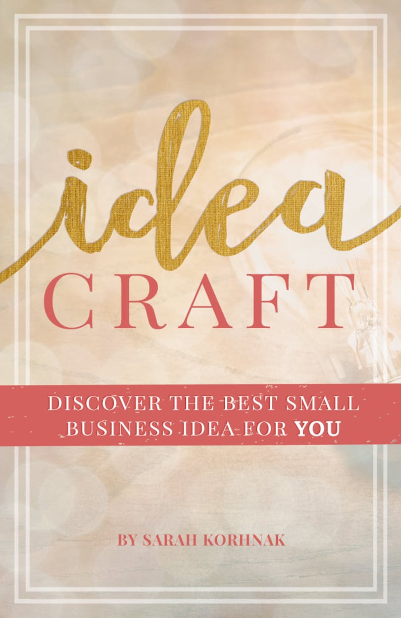 May include: Book cover with a gold textured "idea" and red "CRAFT" text. The cover has a light pink background with a blurred light effect. The text "DISCOVER THE BEST SMALL BUSINESS IDEA FOR YOU" is in red on a pink banner. The author's name, "BY SARAH KORHNAK", is in red at the bottom of the cover.