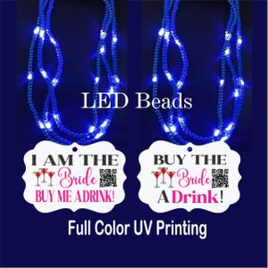 May include: Two blue LED bead necklaces with white tags that read "I AM THE Bride BUY ME A DRINK!" and "BUY THE Bride A Drink!". The image also includes the text "LED Beads" and "Full Color UV Printing".