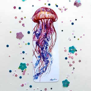May include: A watercolor painting of a jellyfish with a red and purple bell and long, flowing tentacles. The painting is on a white background and has the word "Aquabrain" written in the bottom right corner.