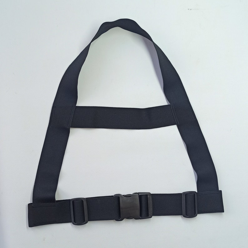 May include: A black adjustable strap with a buckle closure. The strap is made of a thick, durable material and is designed to be worn around the waist or chest.