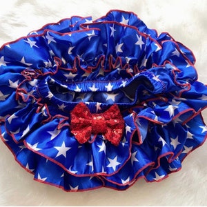 May include: Blue and white star print ruffled bloomers with a red sequin bow.