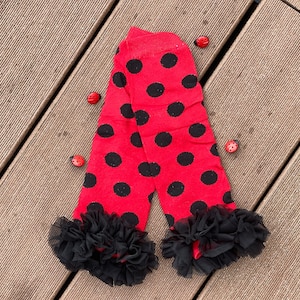 May include: Red and black polka dot leg warmers with black lace trim.