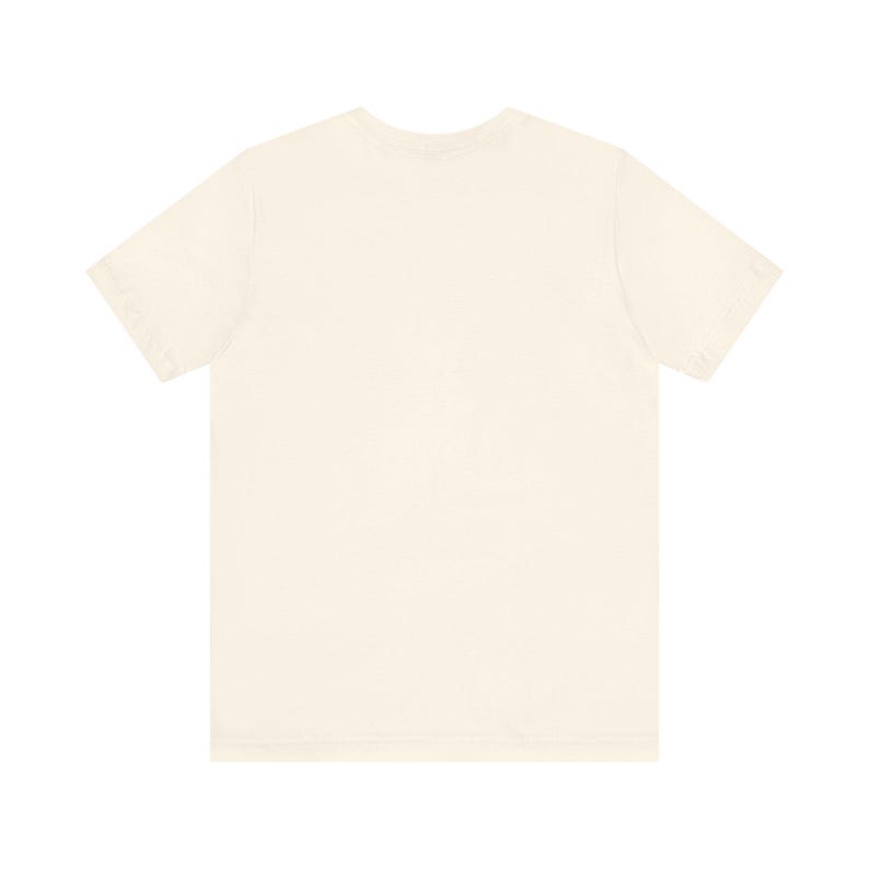 May include: A cream-colored, short-sleeved t-shirt. The shirt has a crew neck and a relaxed fit. The fabric appears to be soft and lightweight, suitable for casual wear. The t-shirt is a solid color with no visible graphics or patterns.