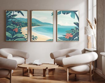 May include: Three framed wall art prints featuring a tropical beach landscape with turquoise water, sandy shores, lush green palm leaves, and vibrant orange hibiscus flowers, displayed in a room with light-coloured chairs and a wooden coffee table.