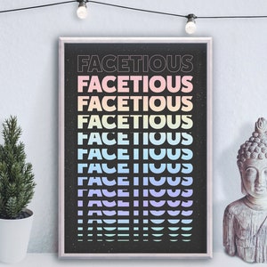 May include: A black and white poster with the word "Facetious" repeated in rainbow colours. The poster has a speckled background and is framed in a white frame.