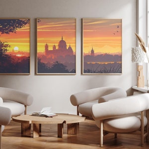 Może przedstawiać: Trzy oprawione wydruki krajobrazów z zachodem słońca z panoramą miasta i kościołem w oddali. Wydruki wiszą na jasnobeżowej ścianie nad drewnianym stolikiem kawowym i dwoma białymi fotelami.