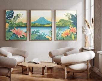 May include: A set of three framed wall art prints featuring a tropical landscape with a central blue mountain, a calm lake, lush green foliage, and vibrant orange flowers. The artwork displays a serene nature scene with a soft, light-coloured sky.