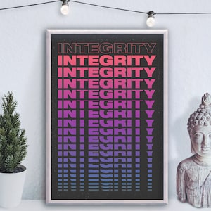 May include: A black and white poster with the word "INTEGRITY" repeated in a gradient of pink, purple, and blue. The poster is framed and hanging on a wall with a string of lights above it.