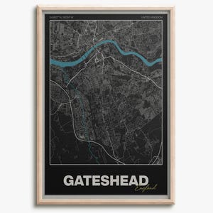 May include: A framed map print of Gateshead, England, featuring a black backdrop with white street lines. A teal river meanders through the city. The city's name is displayed in white at the bottom, with "England" in cursive.