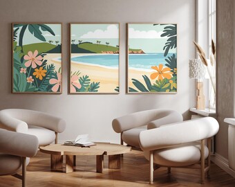 May include: A set of three framed wall art prints featuring a tropical beach landscape with sandy shores, blue ocean water, green hills, and stylised pink and orange flowers in the foreground. The artwork displays a cohesive coastal scene.