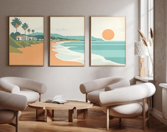 May include: A set of three vertical wall art prints featuring a coastal landscape. The artwork displays a beach scene with palm trees, a house, rolling hills, and a large orange sun over a turquoise ocean, rendered in a flat, graphic illustration style.