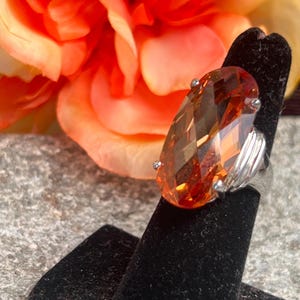 fabulous orange colored stone set in silver tone setting  cocktail ring