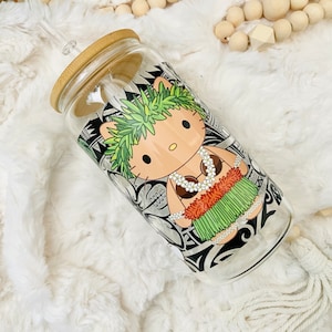 May include: A clear glass reusable water bottle with a bamboo lid and straw. The bottle has a colorful design featuring a cartoon character wearing a flower lei and a grass skirt.