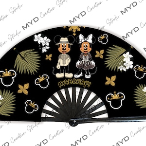May include: A black folding fan with a gold and white design. The fan features Mickey and Minnie Mouse dressed in traditional Filipino clothing. The words "MABUHAY!" are printed on the fan.