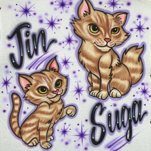 May include: Two cartoon cats with brown and white stripes. The cat on the left is sitting up with its paw raised. The cat on the right is sitting with its tail curled around its legs. The word "Jin" is written above the cat on the left and the word "Suga" is written below the cat on the right. The background is white with purple stars.