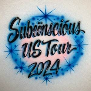 May include: A white background with a blue and pink circle with stars and the text "Subconscious US Tour 2024" in black.
