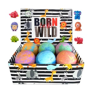 May include: A box of bath bombs with a black and white striped design featuring animal illustrations. The box has the text "Born to be Wild" on the front. The bath bombs are colorful and have a variety of textures. The box includes a variety of small animal figurines.