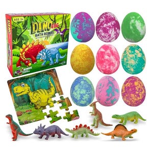 May include: A box of Dino Egg bath bombs with a dinosaur puzzle and 9 colorful bath bombs. The bath bombs are shaped like eggs and have a variety of colors and patterns. The box is labeled "Dino Egg Bath Bombs with Dinosaur Puzzle".