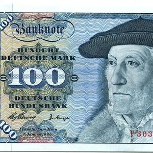 May include: A 100 Deutsche Mark banknote featuring a portrait of a man in a dark beret and fur-trimmed collar. The bill displays the text Banknote, Hundert Deutsche Mark, and Deutsche Bundesbank, with the serial number P 3631374 K printed in red.