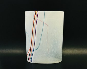 May include: White ceramic vase with a textured surface and colourful lines running vertically and horizontally.