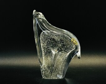 May include: A clear glass sculpture of a polar bear, with a textured surface and air bubbles trapped inside. The sculpture is signed "GM" on the side.