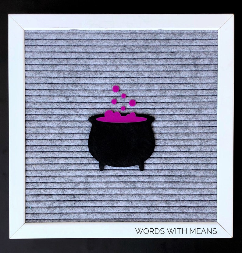 May include: A black felt cauldron with purple felt potion and bubbles on a gray letter board with the text "WORDS WITH MEANS" at the bottom.