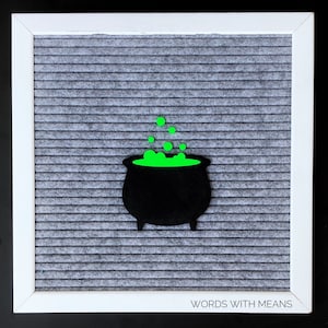 May include: A black cauldron with green bubbling liquid on a gray letter board with the text "WORDS WITH MEANS" at the bottom.
