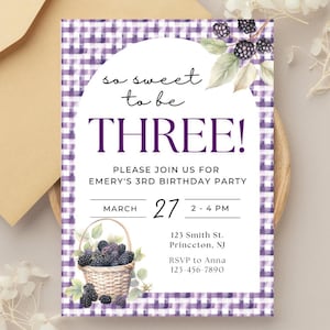 May include: A birthday party invitation with a purple gingham border. The text "so sweet to be THREE!" is in a white oval. The invitation includes details for Emery's 3rd birthday party, with a basket of blackberries and floral accents.
