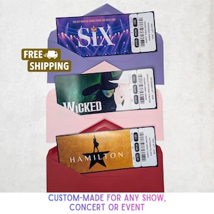 May include: Three musical theatre tickets for "Six", "Wicked", and "Hamilton" are presented in purple, pink, and red envelopes. The tickets show venue details and dates. The text "Custom-Made for Any Show, Concert or Event" is at the bottom.