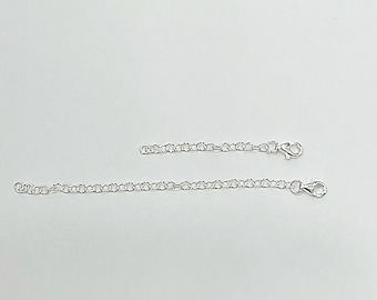 May include: Two silver chain extenders, one longer than the other, with lobster claw clasps.