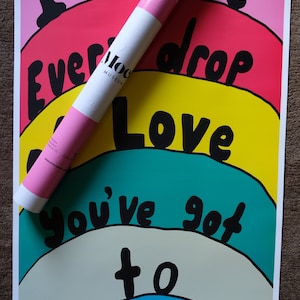 May include: A colorful rainbow-themed poster with the text "I Deserve Every Drop of Love You've Got to Give" in black lettering. The poster is on a white background and has a pink, red, yellow, green, blue, and light blue color scheme.
