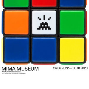 May include: A colorful Rubik's Cube with a pixelated alien face on one side. The cube is displayed in front of a white background with the text "INVADER RUBIKCUBIST" and "MIMA MUSEUM" below. The text "24.06.2022 - 08.01.2023" is also displayed.