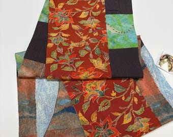 Handmade double-sided silk and cotton pieced scarf. Hues of oranges mixed with green/blues