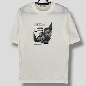 May include: White t-shirt with a black and white image of Humphrey Bogart in the movie "High Sierra". The text "Bogart in one of his most memorable performances" is printed above the image.