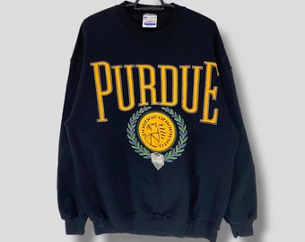 May include: Black sweatshirt with a yellow "Purdue" logo and a gold and green crest featuring a book and a torch.