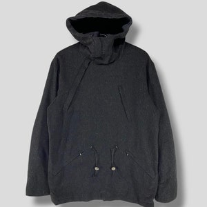 May include: A dark gray hooded jacket with a drawstring at the waist and two pockets on the front.