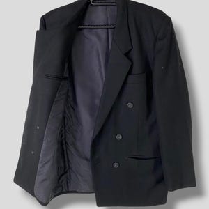 May include: A black double-breasted blazer with a classic cut and a smooth finish.