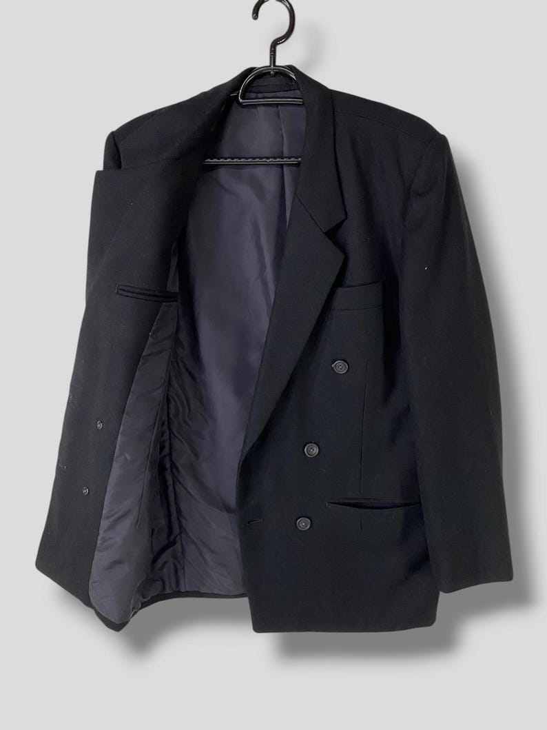 May include: A black double-breasted blazer with a classic cut and a smooth finish.