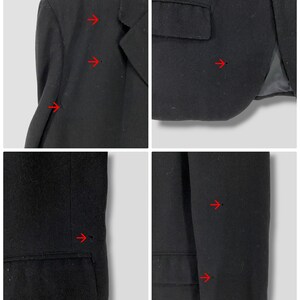 May include: Black blazer with visible signs of wear and tear, including small holes and frayed edges. The blazer has a single button closure and a pocket on the left side.