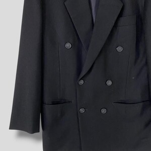May include: A black double-breasted blazer with a classic cut and six buttons.