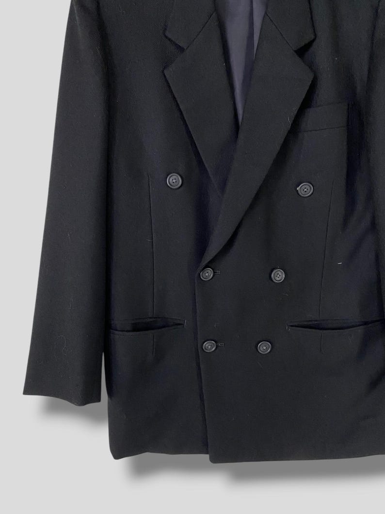 May include: A black double-breasted blazer with a classic cut and six buttons.
